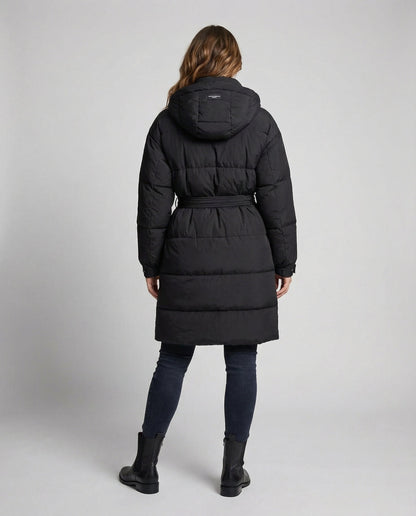 Person wearing a black puffer coat on a light gray background