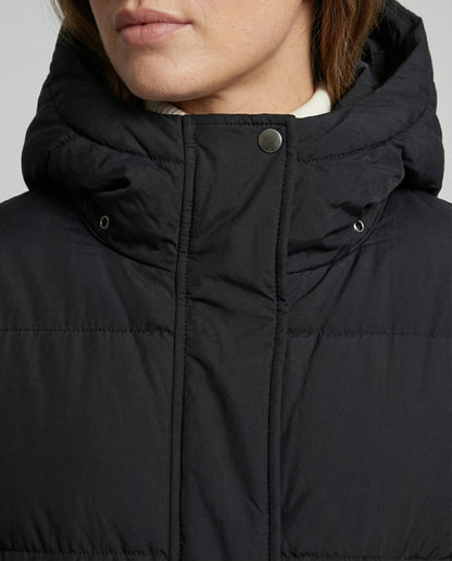 Close-up of a person wearing a black puffer jacket with a hood.