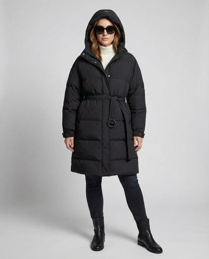 Person wearing a black puffer coat on a gray background