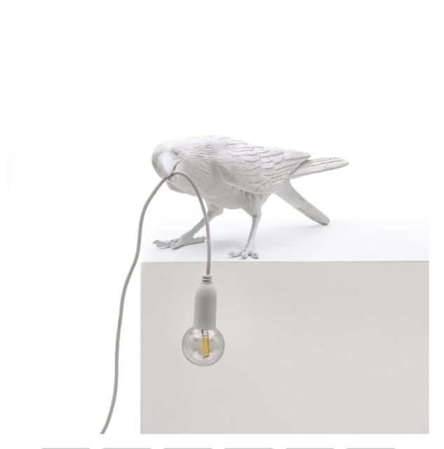 Raven Vägglampa | Veska Vit sittande