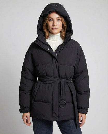 Woman wearing a black puffer coat on a gray background